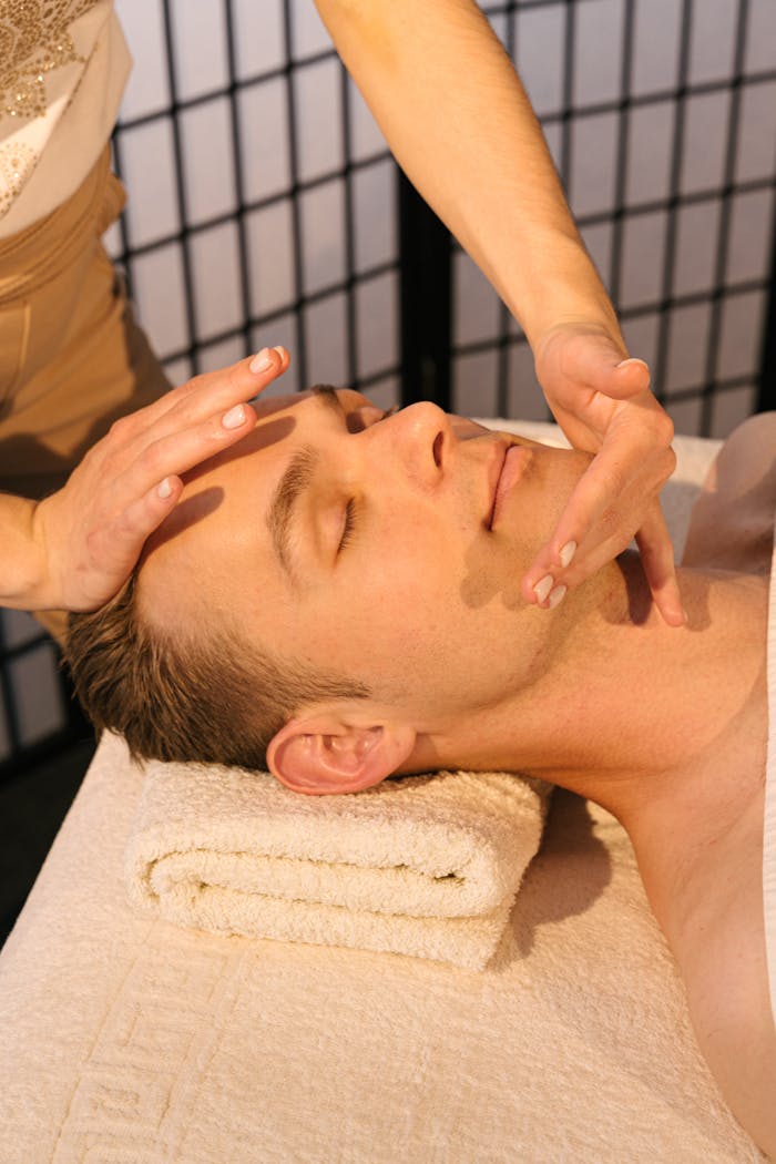 services-01 Man receiving a calming face massage at a professional spa, emphasizing relaxation and wellness.