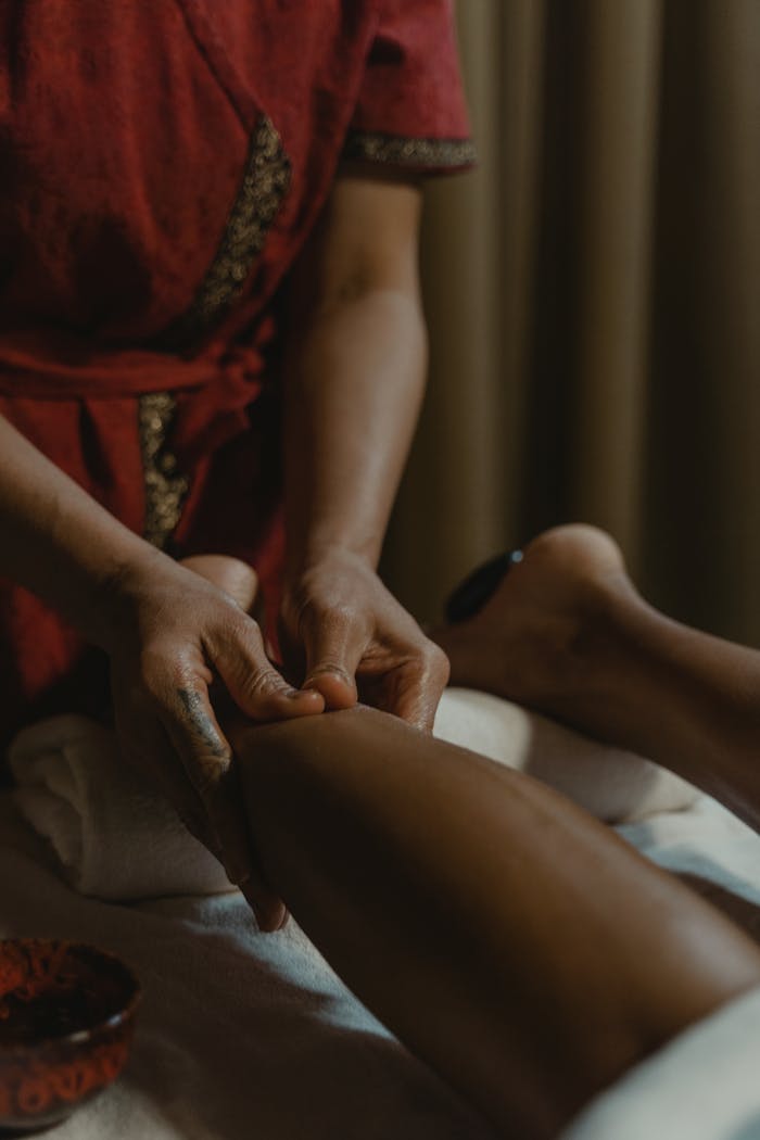 services-03 Close-up of hands giving a therapeutic leg massage at a spa, promoting relaxation and wellness.